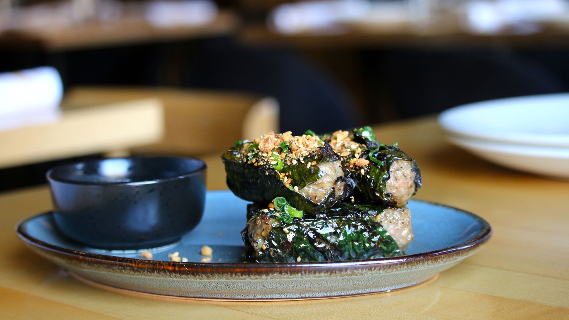 Grilled betel-leaf wraps at HaiSous with dipping sauce