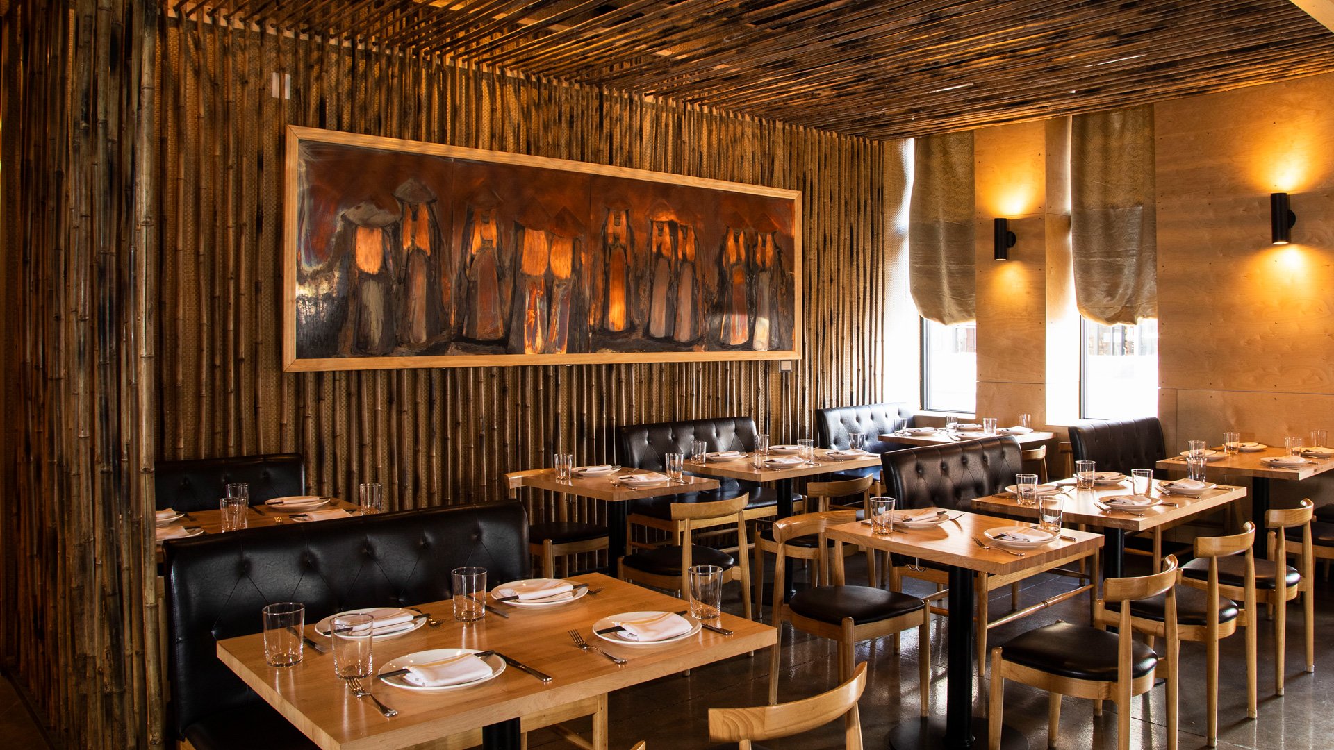 HaiSous front dining room with bamboo walls, copper-toned artwork and timber tables