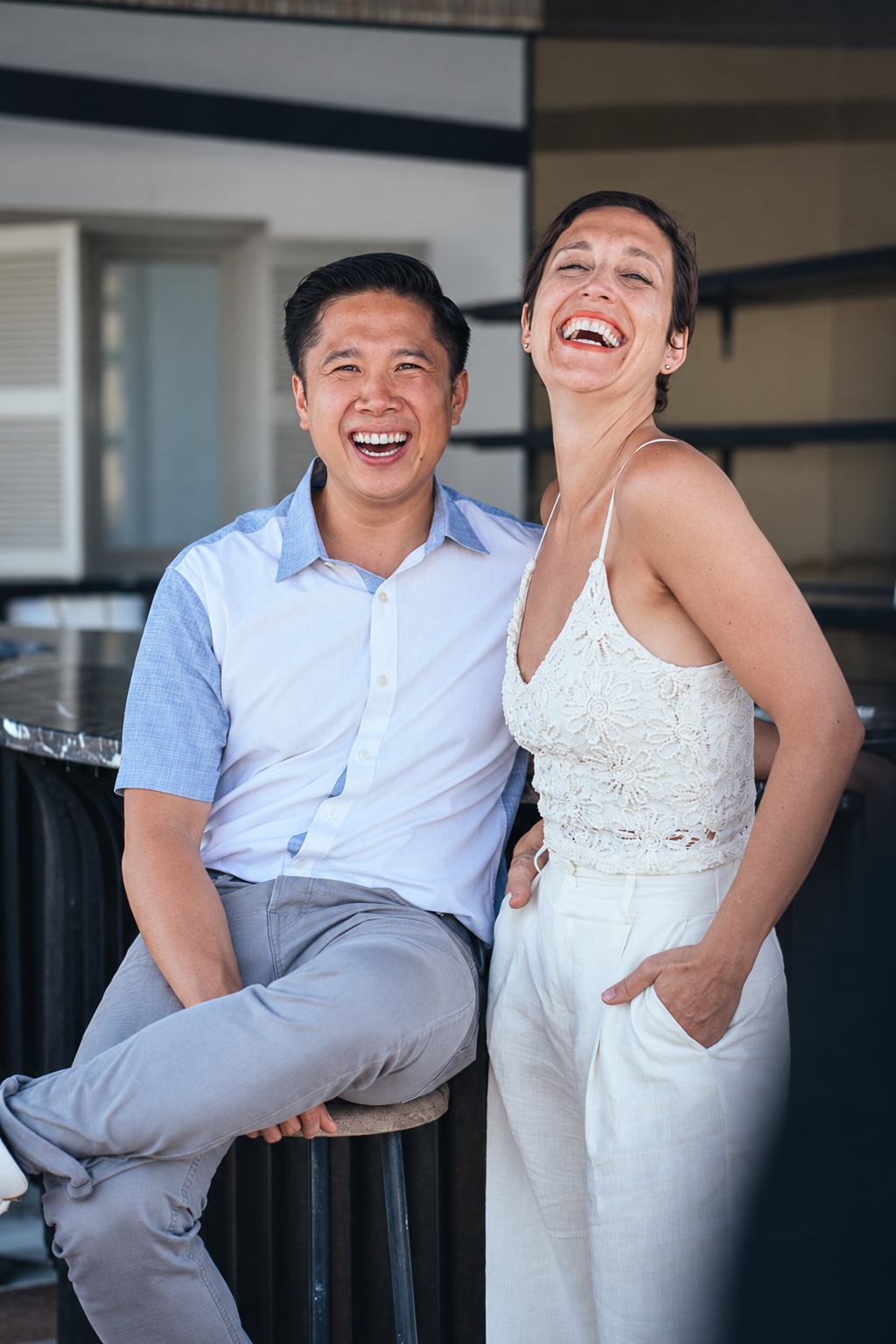 Chef Thai Dang and Danielle Dang laughing together, in a gently AI-refined version of the supplied photograph